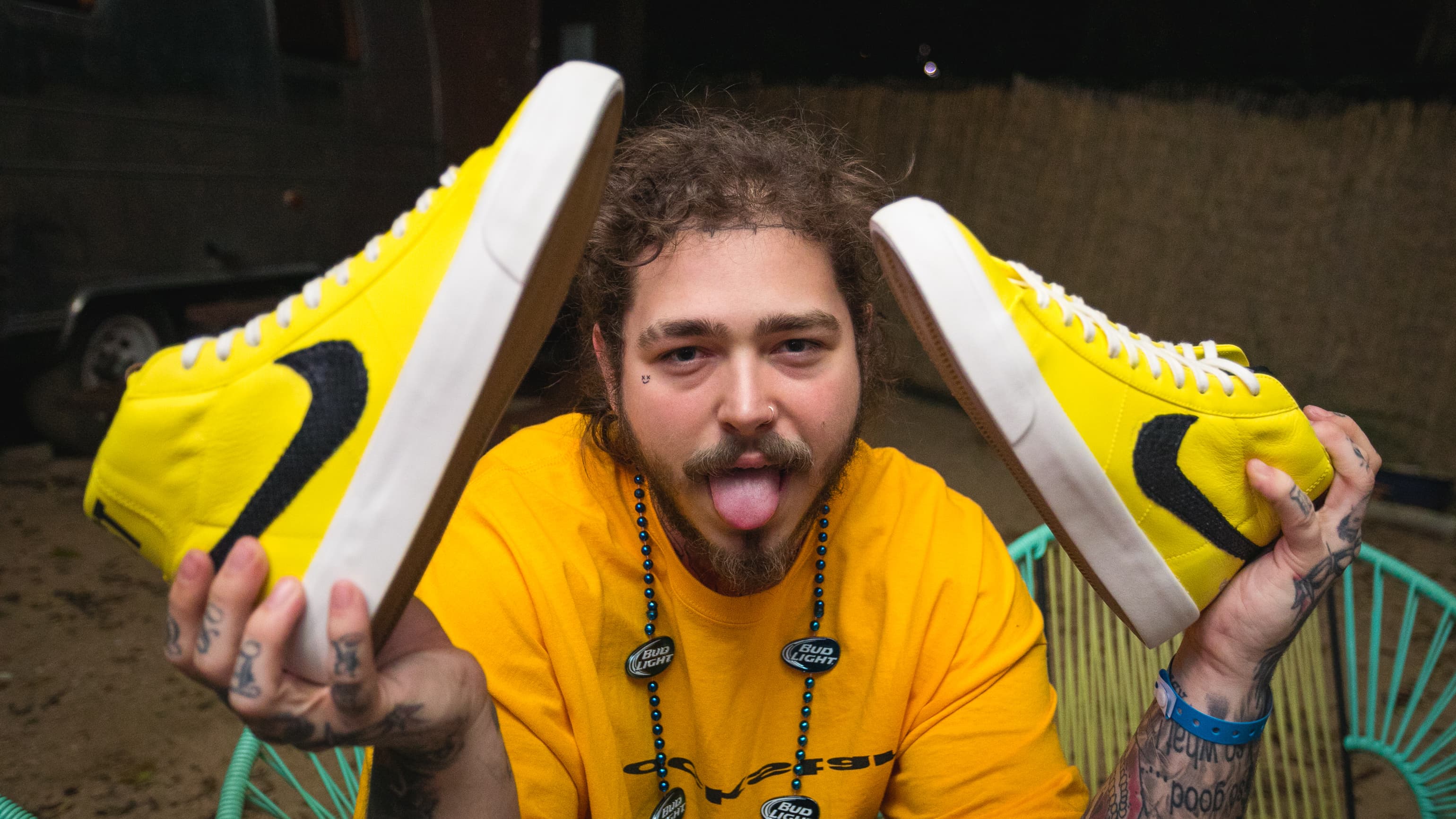 Post Malone holding his 'Rockstar' Nike SB Blazer customs